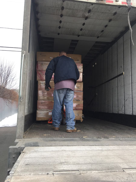 Man unloading mats from truck