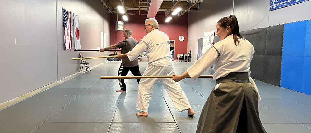 Aikido class performing jo kata