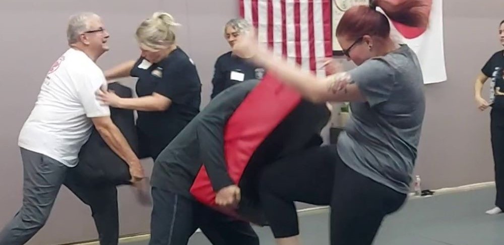 Women fighting in women's self-defense workshop